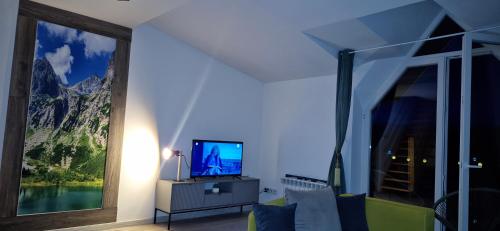 Televisyen dan/atau pusat hiburan di Mountain View Apartament Termy Chochołowskie 5 min