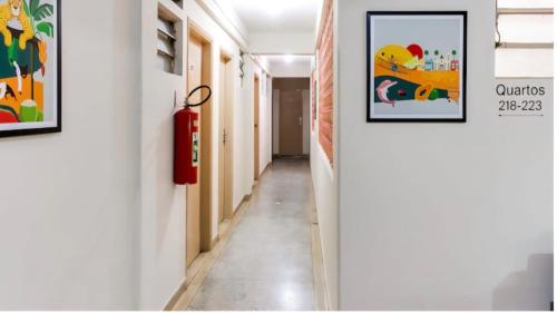 a corridor of a hallway with paintings on the walls at Hotel Nobrega - São Paulo - Aeroporto Congonhas in Sao Paulo