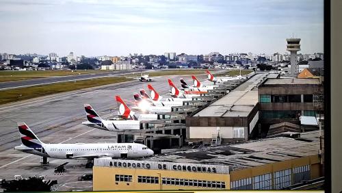 a row of airplanes parked at an airport at Hotel Nobrega - São Paulo - Aeroporto Congonhas in Sao Paulo