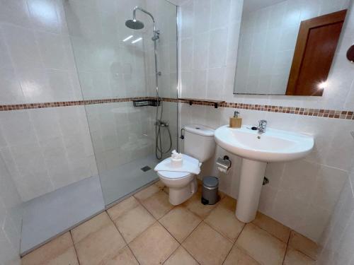 a bathroom with a toilet and a sink and a shower at Anahi Homes Corralejo -Villa Codeso 7 in La Oliva