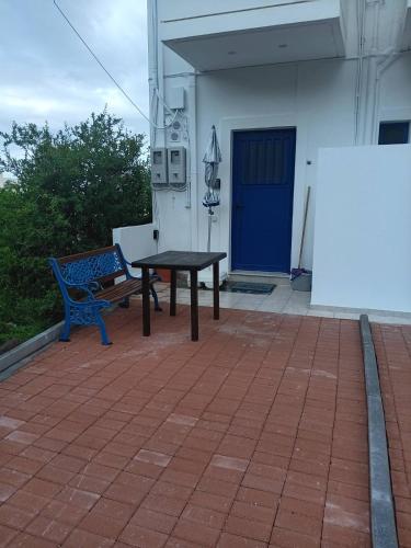 a picnic table and a bench on a patio at Lendas Paradise studio number 1 in Léntas