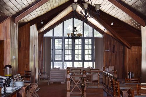 a large window in a room with tables and chairs at Daffodil's Hotel in Nuwara Eliya