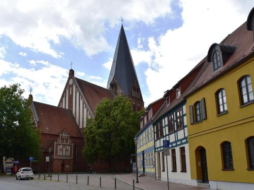a group of buildings in a street with a church at Ferienwohnung Backbord im Zentrum von Röbel in Röbel