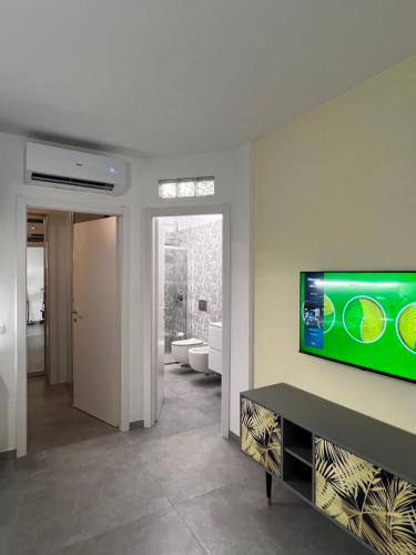 a living room with a flat screen tv on a wall at Maison Belle Montenero Marina in Marina di Montenero