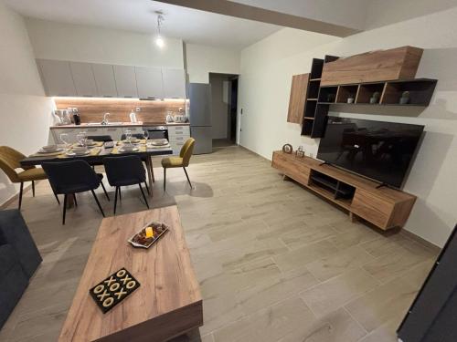 a living room with a dining table and a kitchen at Cavo Levante in Andros