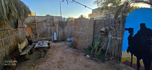 a room with a fence and a bench next to a wall at Dahab house home in Dahab