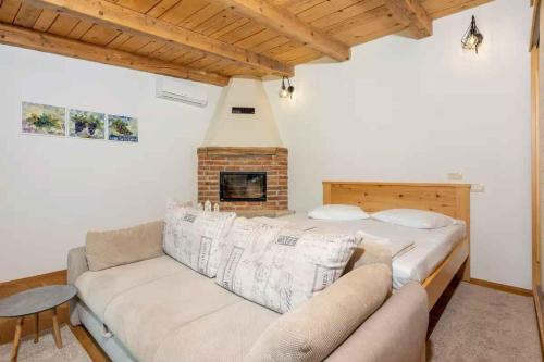 a living room with a couch and a fireplace at Holiday home in Grizane 45282 in Grižane