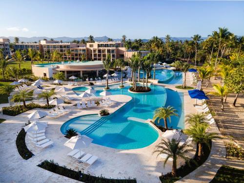 an aerial view of a resort pool with chairs and umbrellas at Viva Miches by Wyndham, a Trademark All Inclusive Resort in Miches