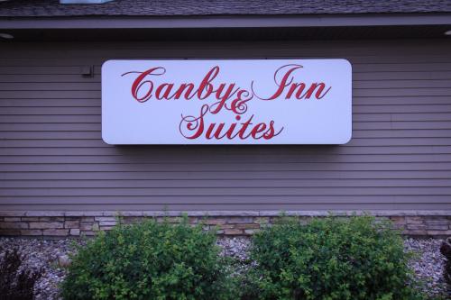 a sign on the side of a house at Canby Inn and Suites in Canby