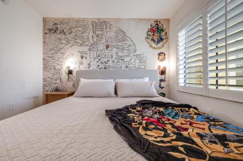 a bedroom with a large bed with a mural on the wall at Harry Potter Suite near Epic & Universal in Orlando