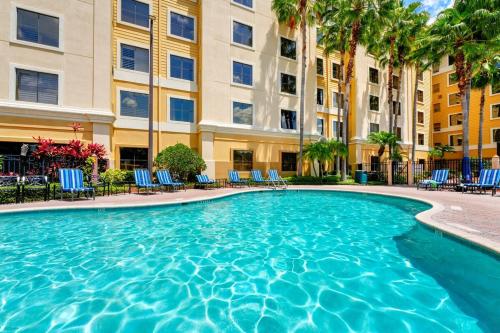 a swimming pool in front of a building at Harry Potter Suite near Epic & Universal in Orlando