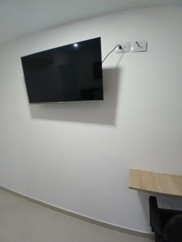 a flat screen tv hanging on a wall at Hotel Plaza Norte Cali in Cali