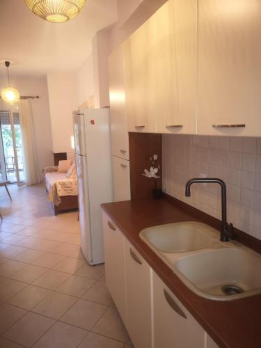 a kitchen with a sink and a refrigerator at Noka Nikiti in Nikiti
