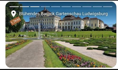 a picture of a large building with a garden at Guests Apartments in Ludwigsburg