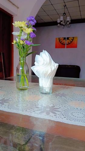 a vase filled with flowers sitting on a table at OSRA HOLIDAY In in Katunayake