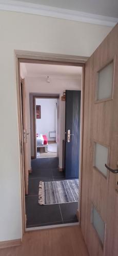 a hallway with a door leading to a room at Pod Górą in Wiśniowa