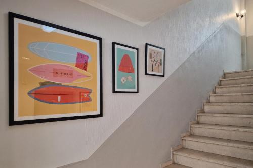 a set of stairs with pictures on the wall at Garner Hotel Cologne - Engelbertz by IHG in Cologne