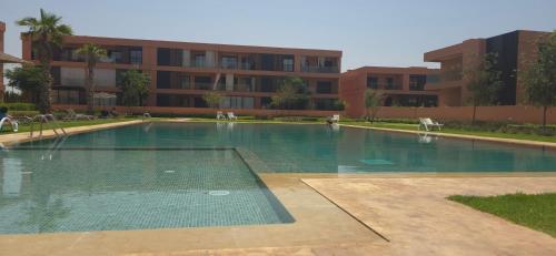 an empty swimming pool in front of a building at Dar Sofia Noria in Marrakech