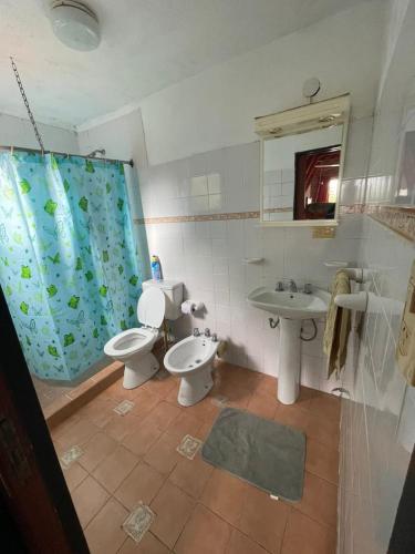 a bathroom with two toilets and a sink at Alpinas San Lorenzo in Merlo