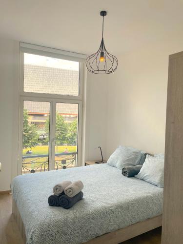 a bedroom with a bed with towels on it at Historic Centre Apartment - Ghent Belfry & St Nicholas Church View in Ghent
