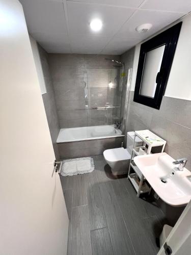 a bathroom with a sink and a tub and a toilet at Top apartment! in Benajarafe