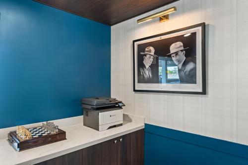 a wall with a picture of a man and a woman at The Ellsworth Hotel, an Ascend Collection Hotel in Williams
