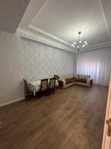 a large living room with a couch and chairs at Seaside luxury apartment in Sumqayyt