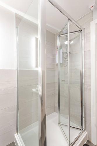 a shower with a glass door in a bathroom at 2-Bed Apartment with Sofa Bed, Sleeps up to 6, Perfect for Groups & Familie in Liverpool
