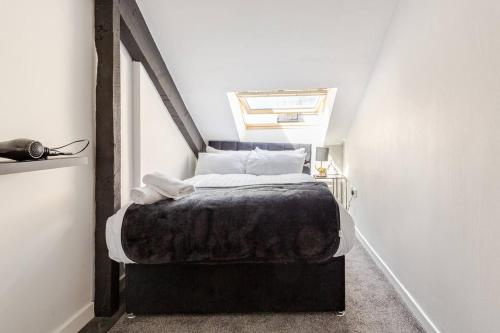 a small bedroom with a bed in a attic at 2-Bed Apartment with Sofa Bed, Sleeps up to 6, Perfect for Groups & Familie in Liverpool