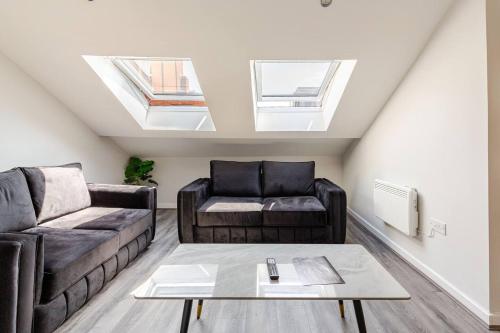 a living room with a couch and a table at 2-Bed Apartment with Sofa Bed, Sleeps up to 6, Perfect for Groups & Familie in Liverpool