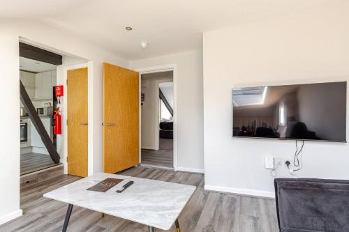 a living room with a table and a mirror on the wall at 2-Bed Apartment with Sofa Bed, Sleeps up to 6, Perfect for Groups & Familie in Liverpool