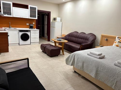a kitchen and a living room with a bed and a couch at Miramar Palace 612S in Sunny Beach