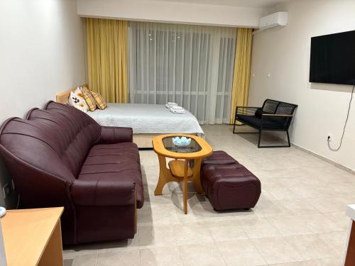 a hotel room with a couch and a bed at Miramar Palace 612S in Sunny Beach