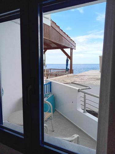 a view of the ocean from a window at Lendas Paradise studio 2 in Léntas
