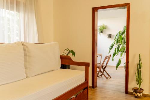 a bedroom with a bed and a mirror and a table at Aiolos Hotel & Discoveries in Prea