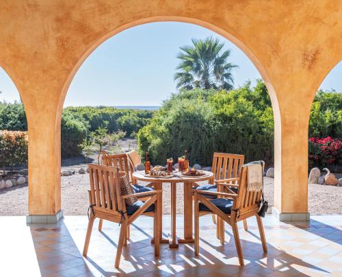 a table and chairs on a patio with a view at Villa Santa Cruz in Todos Santos