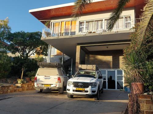 two cars parked in front of a house at Sapphire Main 1 At 54 in Windhoek