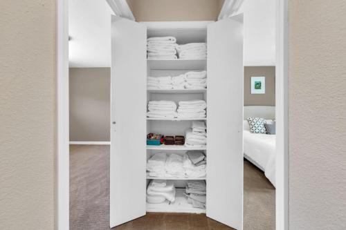 a room with a closet filled with white towels at Reno Retreat-Near Downtown-UNR-Family Fun in Reno