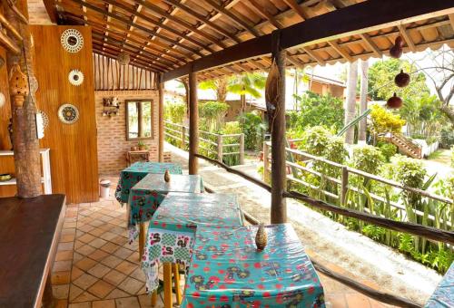 a patio with blue tables and a fence at Pousada Praia da Pipa in Pipa