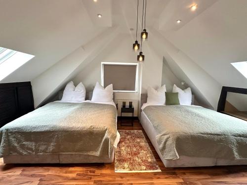 a bedroom with two beds and a mirror at Haus am Wald mit Whirlpool, Garten, Kamin und voll ausgestatteter Küche in Stolberg
