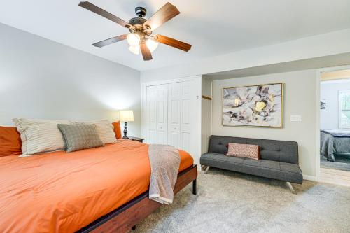a bedroom with a bed and a ceiling fan and a couch at about 1 Mi to Dtwn Alpharetta Home with Screened Porch! in Alpharetta
