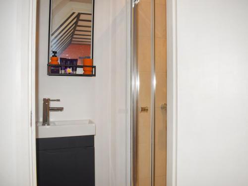 a bathroom with a sink and a shower at Kingfisher Granary in Ashburnham