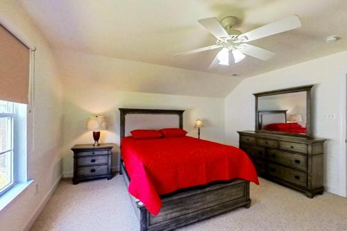 a bedroom with a red bed and a ceiling fan at Wedgefield --- 27 Wedgefield in Ocean View