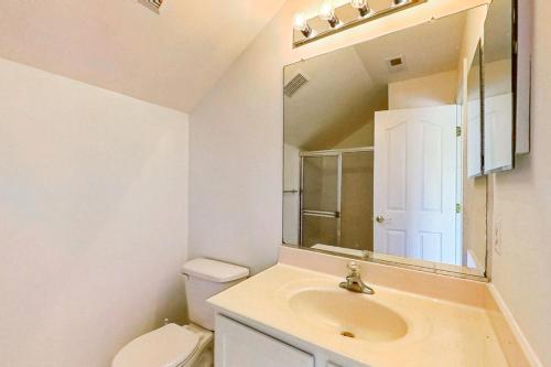 a bathroom with a sink and a toilet and a mirror at Wedgefield --- 27 Wedgefield in Ocean View