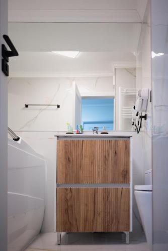 a bathroom with a sink and a toilet at Cozy Hideaway Your Urban Escape in Craiova