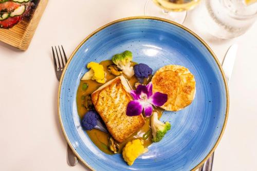 a blue plate of food with toast and vegetables at Delta Hotels by Marriott Prince Edward in Charlottetown