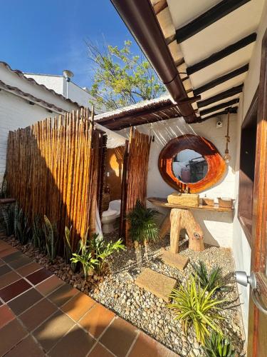 a backyard with a fence and a mirror at Rustico Hostel Barichara in Barichara