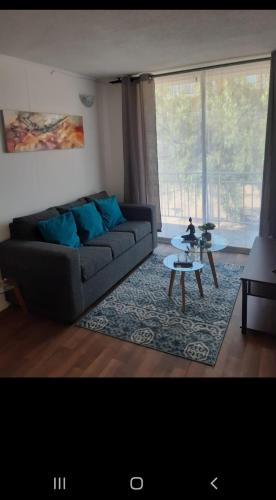 a living room with a couch and a table at Depto 202 viracocha in Ovalle