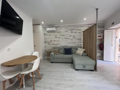 a living room with a couch and a table at Blue Bay Beach Apartment - Laura in Sesimbra