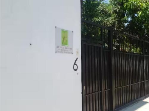 a black gate with a sign on the door at ESTANCIA Santa Teresa in Temixco